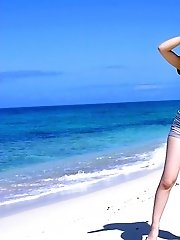 Lovely Asian beach bunny strips and shows her big tits and hot ass